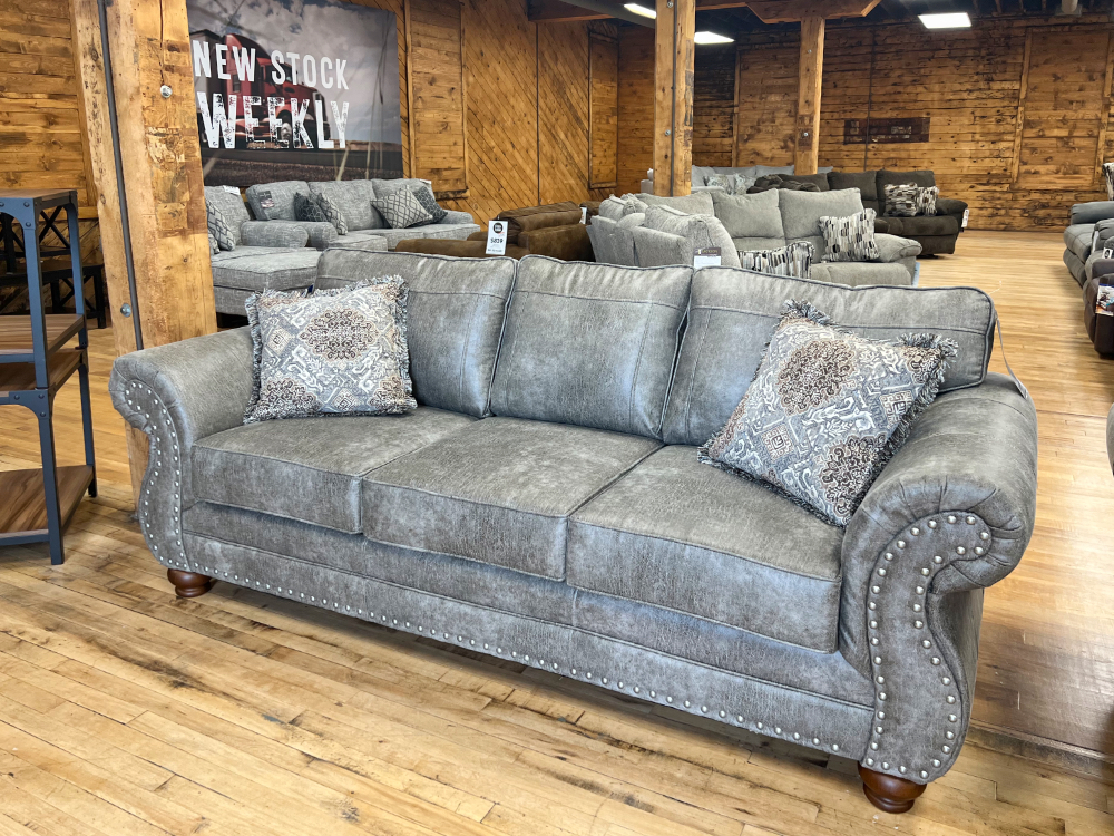 traditional lodlge style leather look sofa in beige in the stock room furniture warehouse in rockford, il