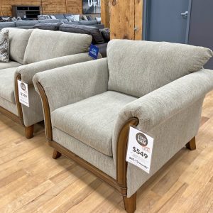 graceful beige armchair with hardwood frame in the stock room furniture warehouse