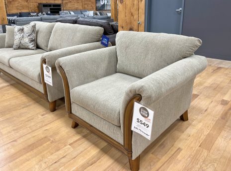 graceful beige armchair with hardwood frame in the stock room furniture warehouse