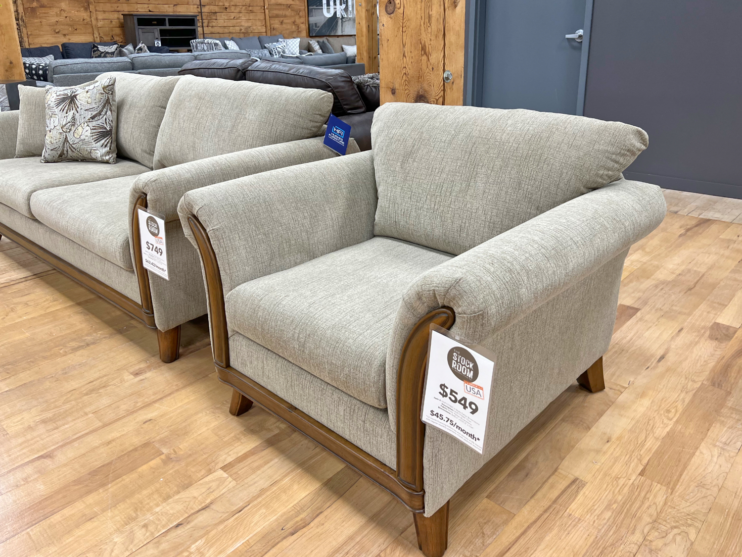 graceful beige armchair with hardwood frame in the stock room furniture warehouse