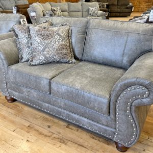 traditional lodge style sofa with nailhead trim in leather-look beige