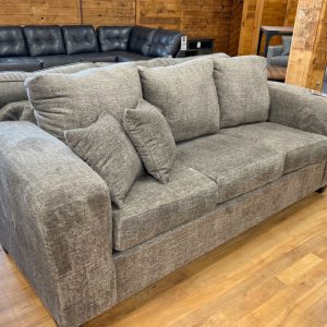 three seat sofa with extra wide track arms in cozy taupe fabric in the stock room furniture warehouse in rockford, il