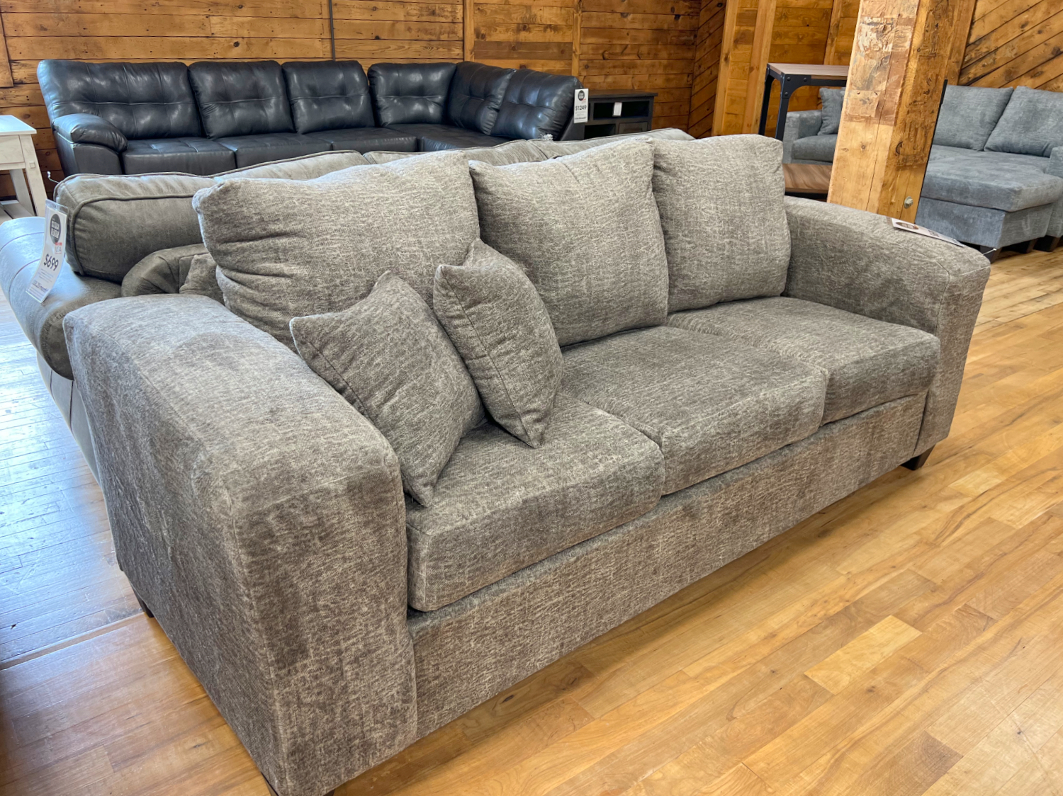 three seat sofa with extra wide track arms in cozy taupe fabric in the stock room furniture warehouse in rockford, il