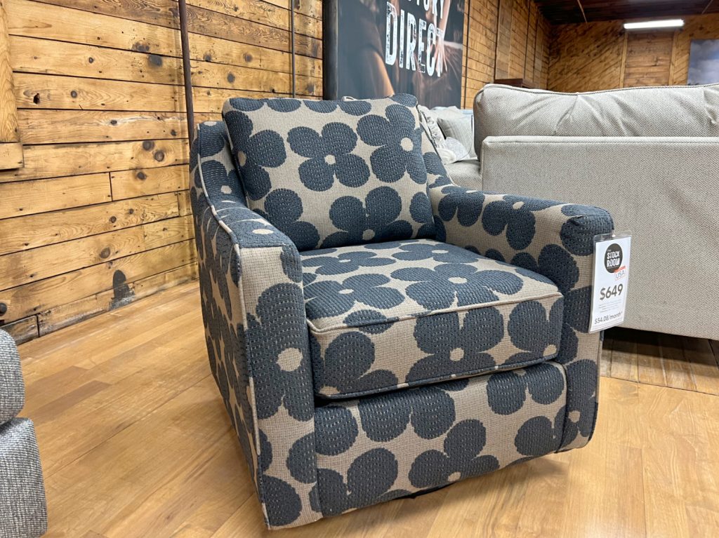 super cute and trendy black & brown mod flower pattern swivel glider chair in stock now in The Stock Room discount furniture warehouse in Rockford, IL