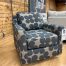 super cute and trendy black & brown mod flower pattern swivel glider chair in stock now in The Stock Room discount furniture warehouse in Rockford, IL