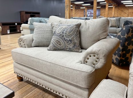 beige farmhouse chair and a half with nailhead trim in the stock room discount furniture warehouse in rockford, il