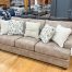 homey beige fabric sofa with nailhead trim in the stock room furniture store in rockford, il