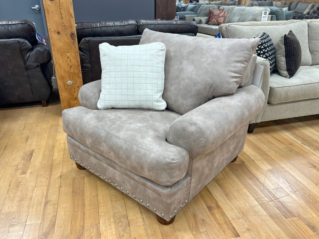 beige cottage sofa with nailhead trim in the stock room discount furniture store in rockford, il