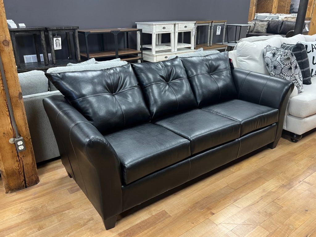 modern transitional black leather-look sofa in stock in the stock room discount furniture warehouse in rockford, il