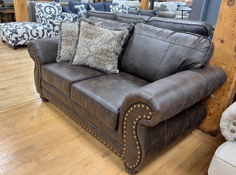 traditional lodge style leather-look loveseat in the stock room discount furniture warehouse in rockford, il