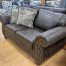 traditional lodge style leather-look loveseat in the stock room discount furniture warehouse in rockford, il