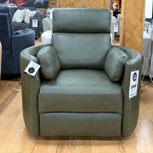 Modern olive green leather recliner chair with integrated side bolster pillows displayed on a light hardwood floor at The Stock Room showroom.