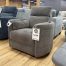 A contemporary dark taupe upholstered reclining armchair with a high backrest.