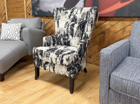 Tezza-8412 A modern wingback armchair with an abstract black and white pattern and dark wood legs.