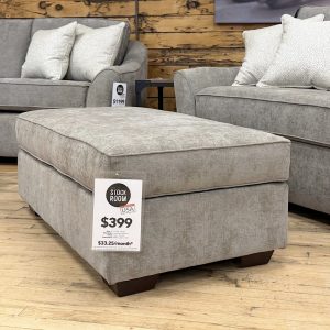 Tezza-8989 A contemporary oversized upholstered ottoman in a neutral taupe-grey fabric.