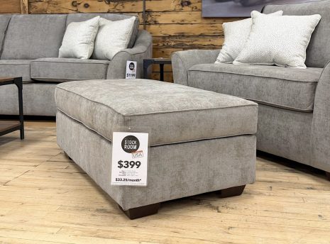 Tezza-8989 A contemporary oversized upholstered ottoman in a neutral taupe-grey fabric.